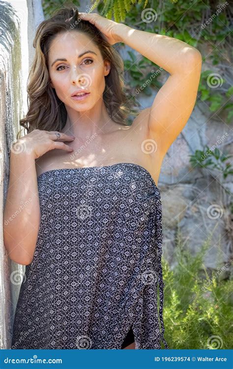 Lovely Brunette Bikini Model Posing Outdoors In A Urban Environment