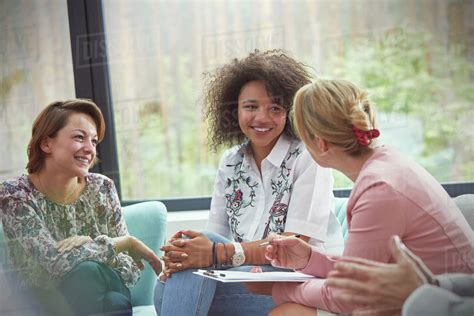Smiling Women Talking In Group Therapy Session Stock Photo Dissolve