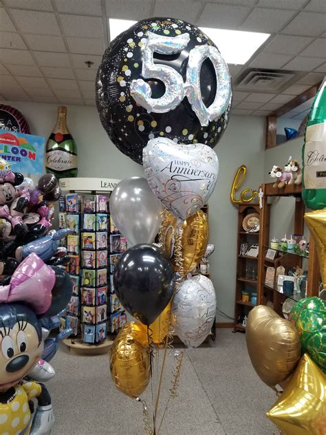 A Bunch Of Balloons That Are In The Shape Of Mickey Mouse And Minnie Mouses