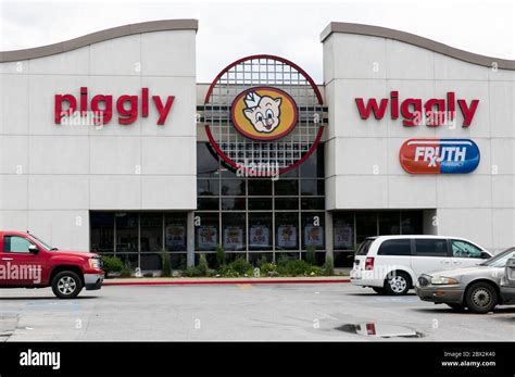 A Logo Sign Outside Of A Piggly Wiggly Retail Grocery Store Location In