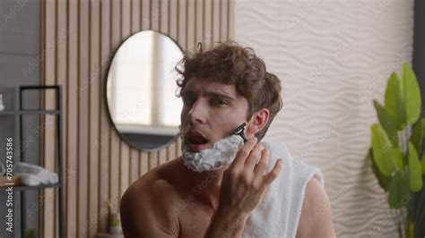 caucasian millennial guy man funny carefree comical humorous male with foamy beard with shaving