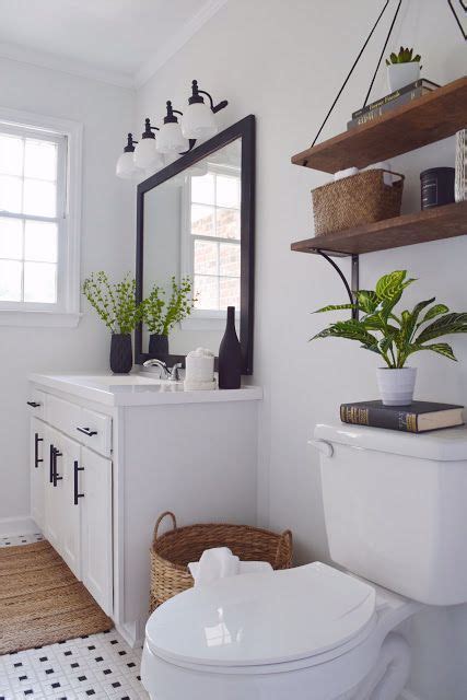 We love how this dining room features two varieties of chairs that share the same blonde wood tone. Black and White Bathroom with Wood Accent - DIY Modern ...