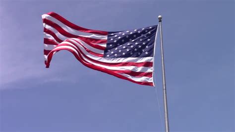 American Flag Flag Blowing In The Wind Flag Against A Blue Sky Creazilla