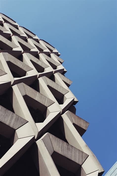 The Corner Of An Architectural Building Against A Blue Sky