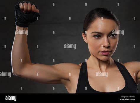Young Woman Flexing Muscles In Gym Stock Photo Alamy