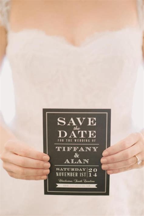 A Woman In A Wedding Dress Holding Up A Sign That Says Save Date For