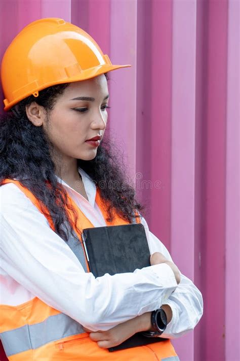 portrait of female worker in cargo containers in shipping container yard woman holding walkie