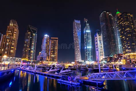 Dubai Marina Skyline At Night With Boats In The Harbor United Arab