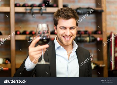 Uploaded at november 03, 2019. Handsome Man Holding A Glass Of Wine Stock Photo 119170141 : Shutterstock