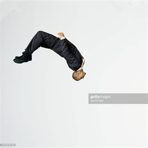 Young Man Wearing Suit Performing Backflip Side View High Res Stock