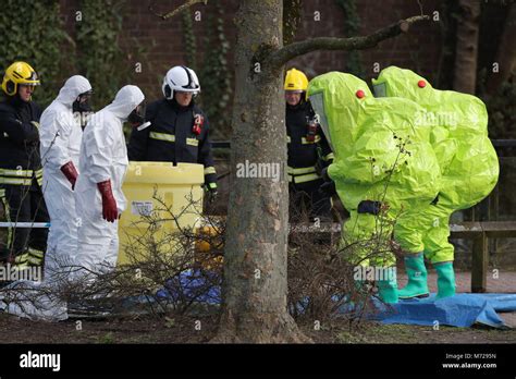 Personnel in hazmat suits wait for decontamination after securing a