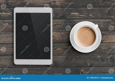 Coffee Cup And Tablet Pc Similar To Ipad On Dark Wooden Table Top View