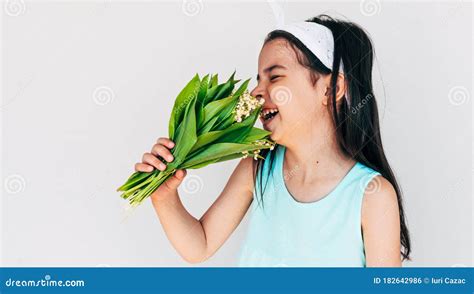 Image Of Joyful Child Holds The Bunch Of White Flowers For Her Mother