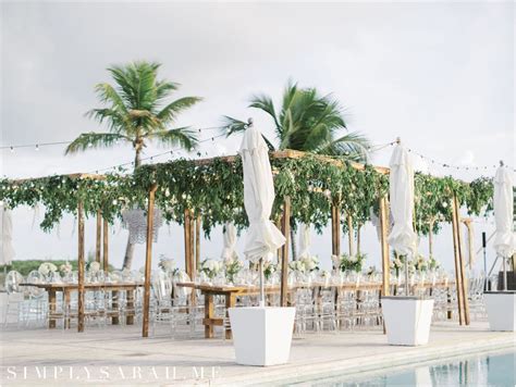 Tropical Wedding Reception Bar Complete With Palm Trees And Flowers At