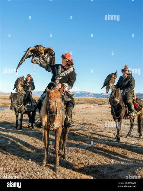 Three Kazakh Eagle Hunters With Their Eagles Western Mongolia Stock