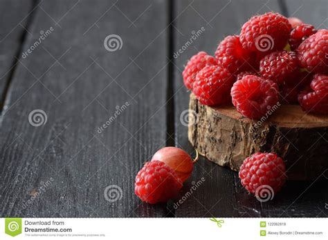 Fresh And Sweet Berries Heap Of Red Raspberries On Wood Slab On Stock