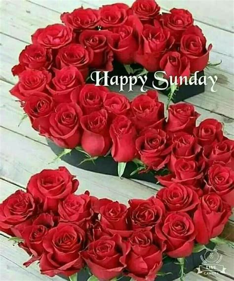A Heart Shaped Box Filled With Red Roses On Top Of A Wooden Table Next To The Words Happy Sunday