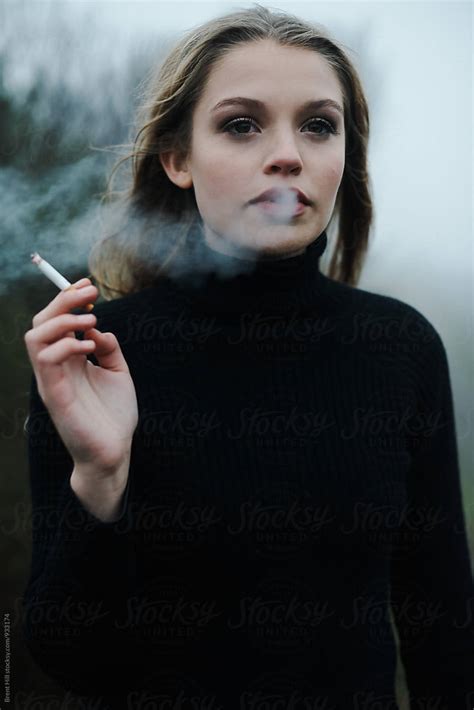 Portrait Of A Young Woman Smoking By Stocksy Contributor Brent Hyll