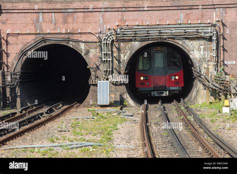 London Underground Tube Train Emerging From A Tunnel On The Northern