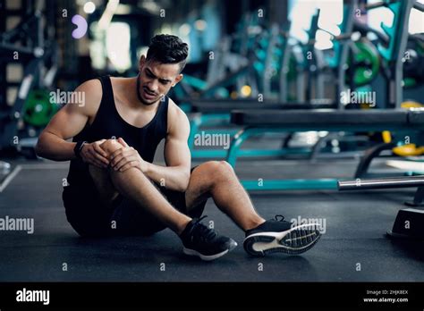 Sport Trauma Young Arab Male Athlete Touching His Hurted Knee At Gym