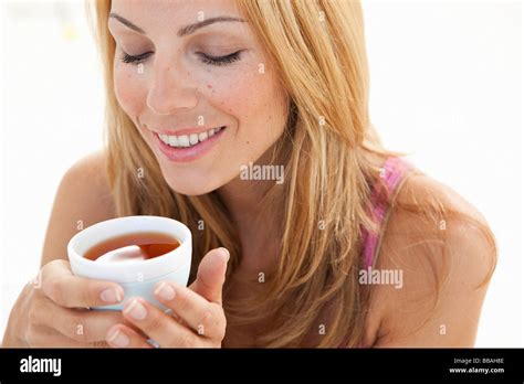 Young Woman Enjoying Cup Of Tea Stock Photo Alamy