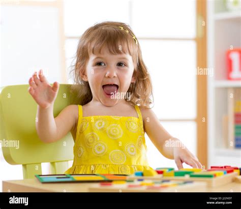 Little Girl Kid Playing With Logical Toys Child Sorting And Arranging