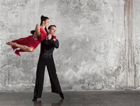 Beautiful Couple In The Active Ballroom Dance On Wall Stock Photo