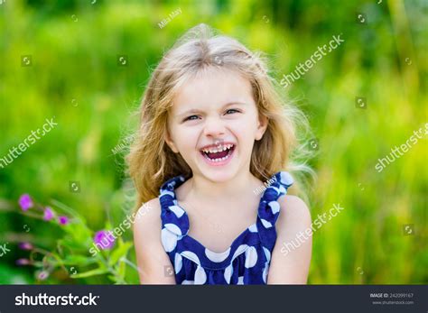 Fanny And Beautiful Laughing Little Girl With Long Blond Curly Hair