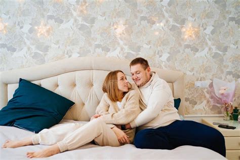 A Happy And Loving Couple Hugs On The Bed Stock Photo Image Of