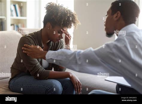 Black Man Psychologist Comforting Upset Woman Patient Stock Photo Alamy