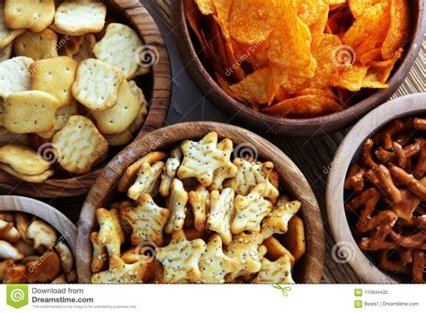 Salty Snacks Pretzels Chips Crackers In Wooden Bowls Stock Photo