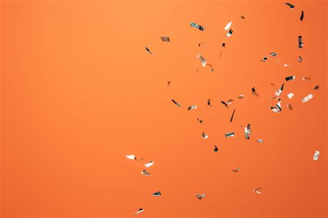 Shiny Silver Confetti On Orange Background Free Stock Photo And Image