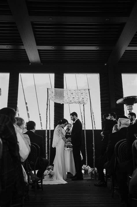 Black And White Photograph Of A Bride And Groom At The Alter During
