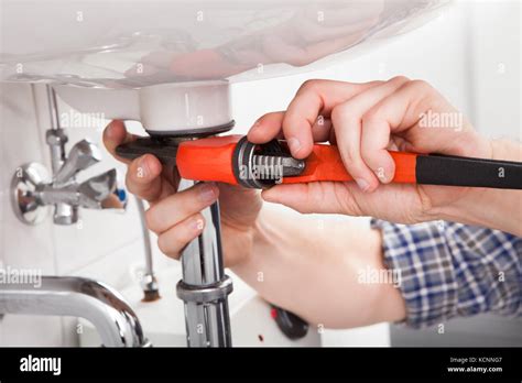 Portrait Of Male Plumber Fixing A Sink In Bathroom Stock Photo Alamy