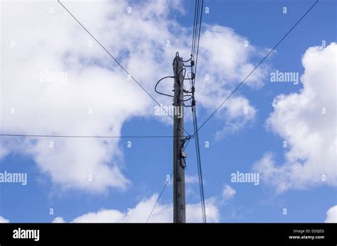 Overhead Electricity Cables Carried On A Pole In A Village Stock Photo