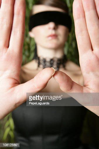 Blindfolded Young Woman Holding Hands In Front Of Her High Res Stock