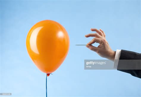 Balloon Attacked By Hand With Needle High Res Stock Photo Getty Images