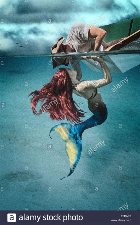 Download This Stock Image Redhead Siren Luring A Pirate To Lean Into