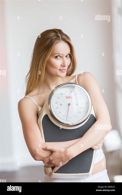 Woman Holding On A Scale Stock Photo Alamy