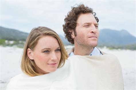 couple wrapped in blanket at beach stock image image of peaceful