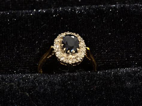 Lot An 18kt Gold Ring Set With A 1ct Sapphire And Approximately 014cts Of Diamonds Size N