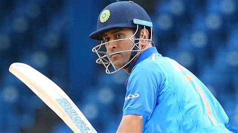 Ms Dhoni With Bat Is Wearing Blue Sports Dress And Helmet Standing In