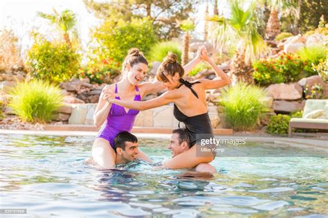 Couples Playing In Swimming Pool Photo Getty Images