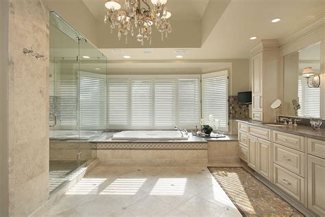 Bathroom Featuring High Ceiling With Chandelier Glass Shower Area