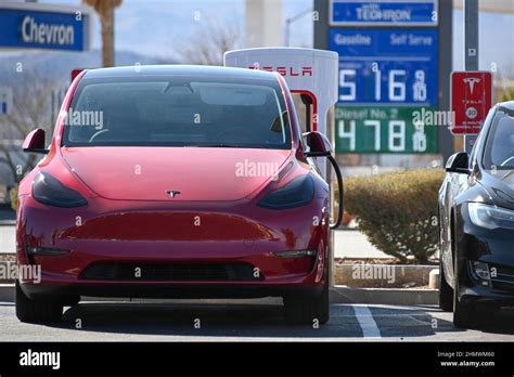 Tesla Model Y Cars Are Seen Charging At Tesla Super Chargers With High