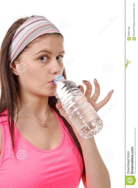Portrait Of Young Woman Drinking Water After Sporting On White Stock