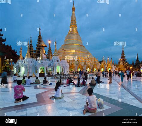 View Of Shwedagon Pagoda At Dusk With Pilgrims Yangon Myanmar Stock