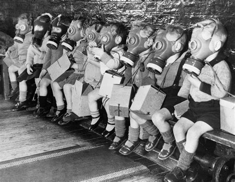 Toddlers On Bench In Gas Masks During Wwii Vintage Everyday