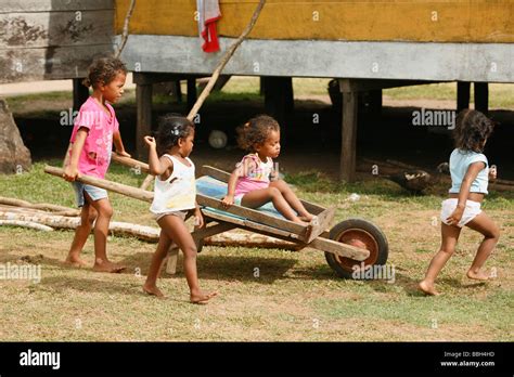 Children Pushing Each Other In A Wheelbarrow Hi Res Stock Photography