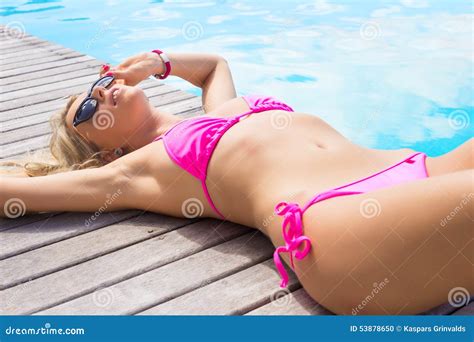 Woman Sunbathing By The Pool Stock Photo Image